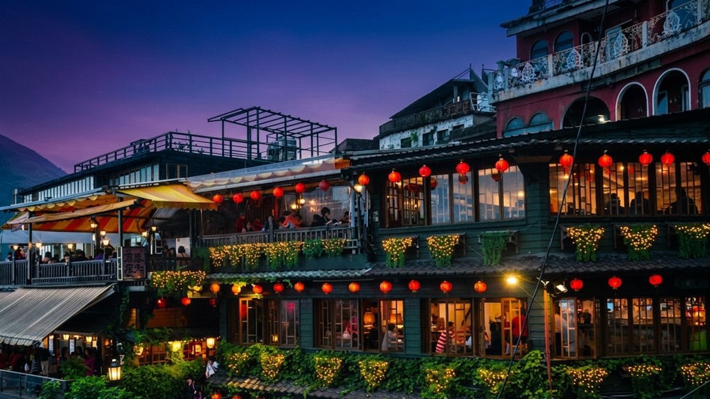 Jiufen teahouses lit at twilight under a purple sky